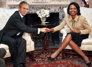 Bush poses with a White House official during his brief stopover.